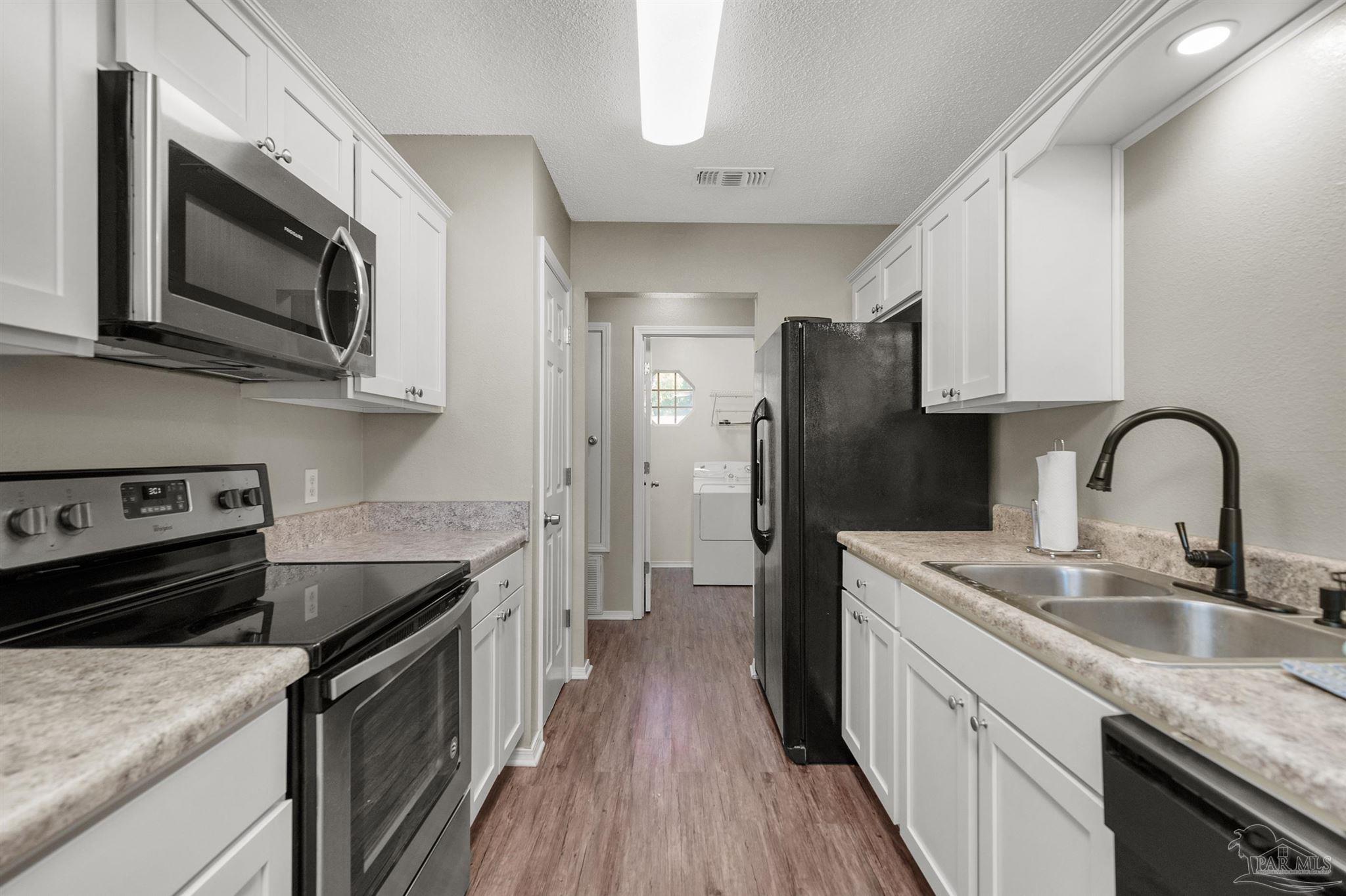 5499 Chantilly Circle Milton, FL 32583 - Photo 8 of 24 a kitchen with stainless steel appliances granite countertop a sink dishwasher stove and refrigerator