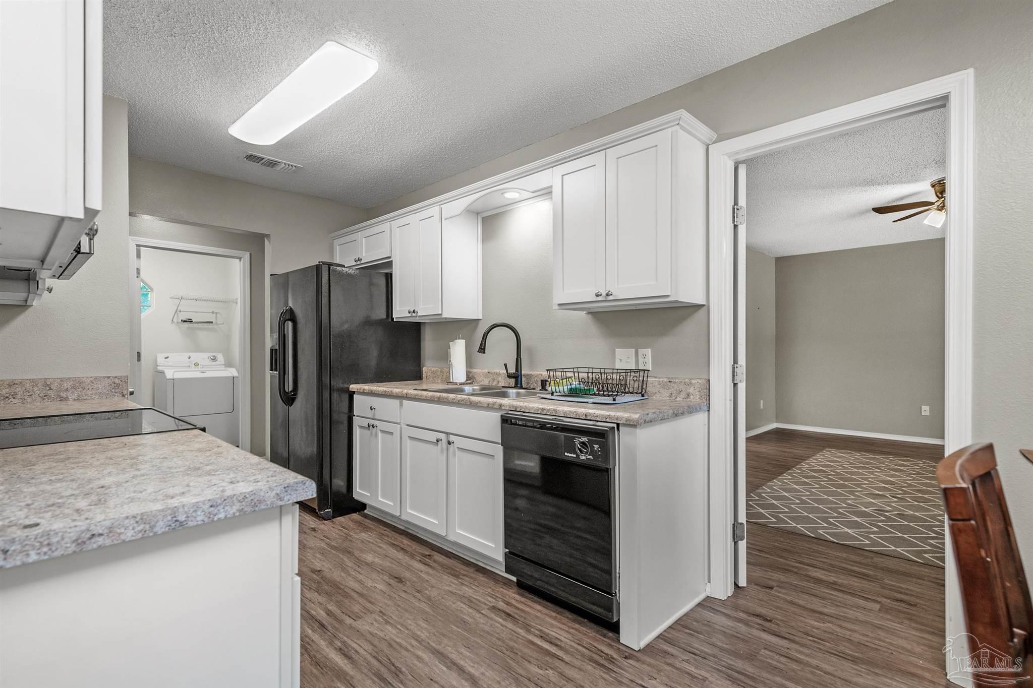 5499 Chantilly Circle Milton, FL 32583 - Photo 10 of 24 a kitchen with stainless steel appliances granite countertop a stove and a refrigerator