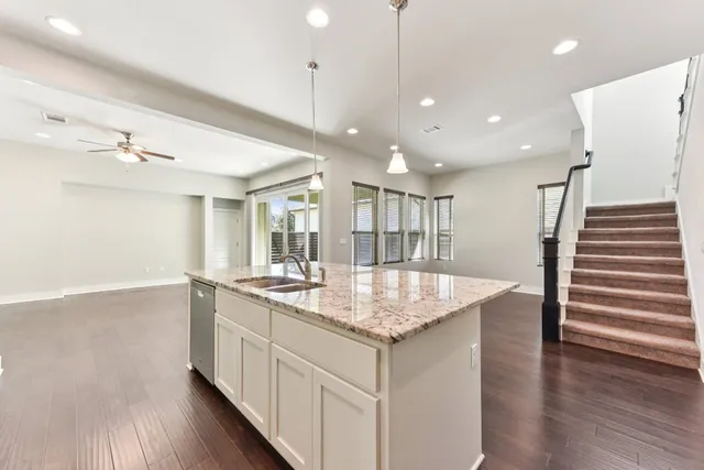 a kitchen with stainless steel appliances granite countertop a sink a oven and a refrigerator