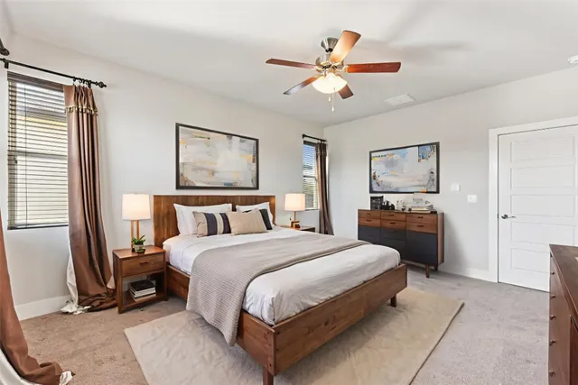 a spacious bedroom with a bed and a chandelier