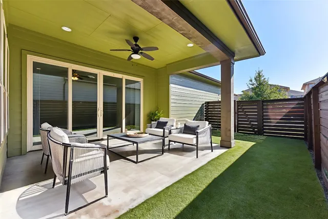 a building outdoor space with patio furniture and garden