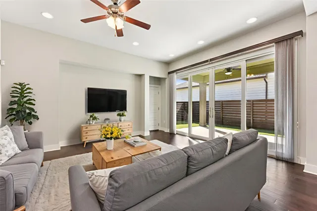 a living room with furniture tv and a large window