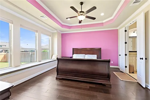 a living room with furniture a flat screen tv and a large window