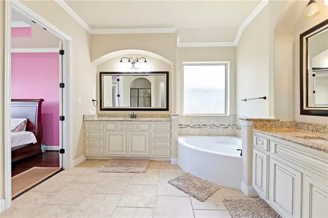 a bathroom with a bathtub sink and mirror