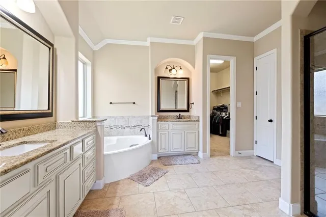 a spacious bathroom with a sink a mirror and a bathtub