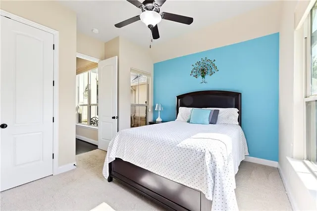 a bedroom with a bed and ceiling fan