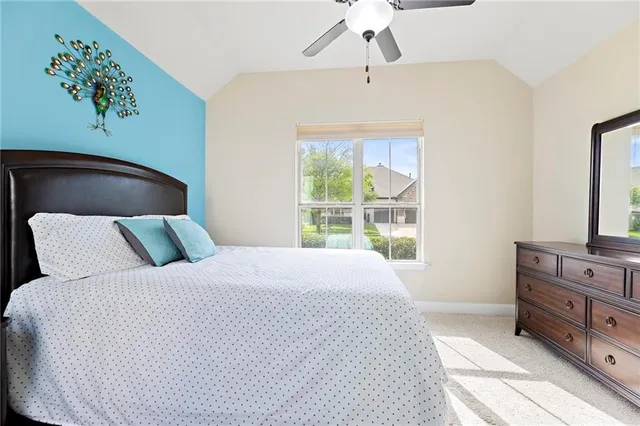 a bedroom with a large bed and a dresser