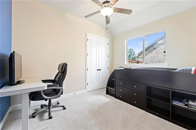 a bedroom with a bed and a desk