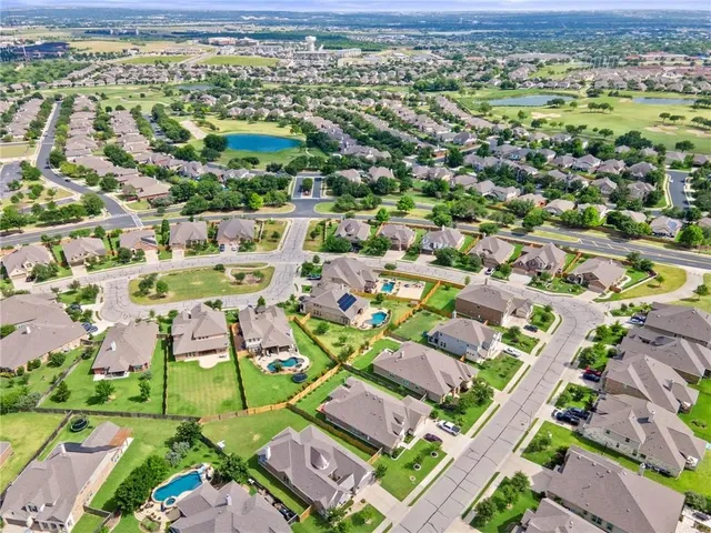 an aerial view of residential houses with outdoor space