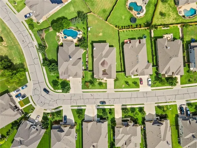 an aerial view of residential houses with outdoor space