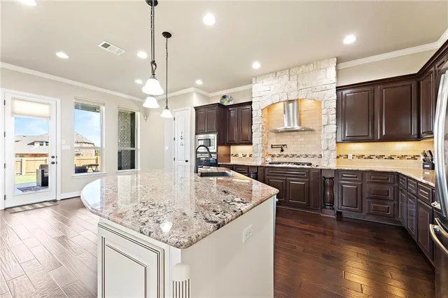 a kitchen with kitchen island granite countertop counter top space appliances and a center island