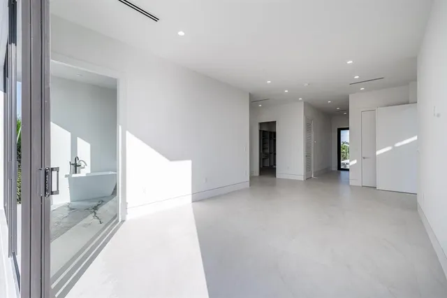 a view of a hallway with a livingroom and furniture