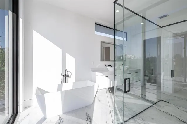 a spacious bathroom with a bathtub and a shower