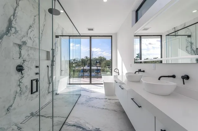 a spacious bathroom with a tub sink and mirror