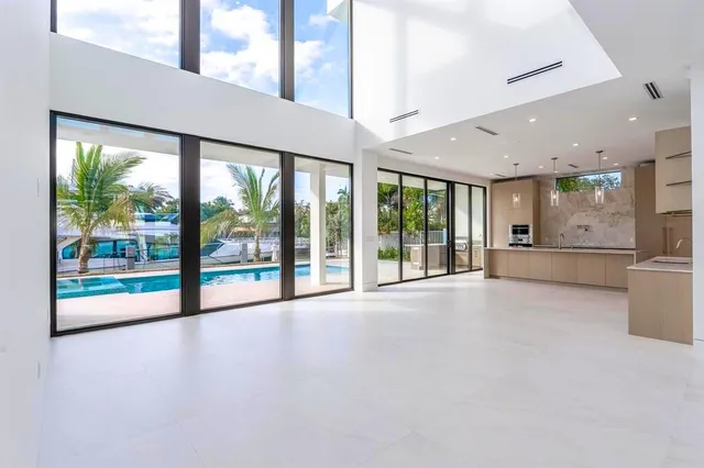 a view of an empty room with a floor to ceiling window and an empty room