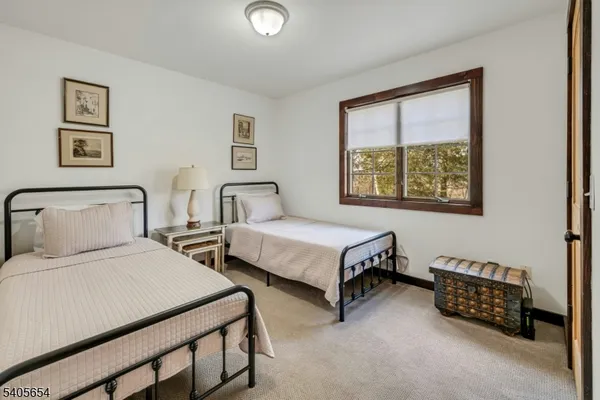 a bedroom with two beds and a window