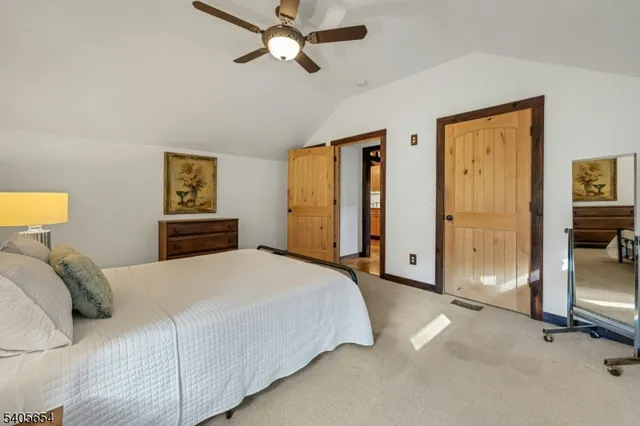 a bedroom with a bed and a lamp