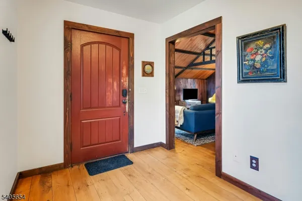 a view of a hallway with wooden floor and closet