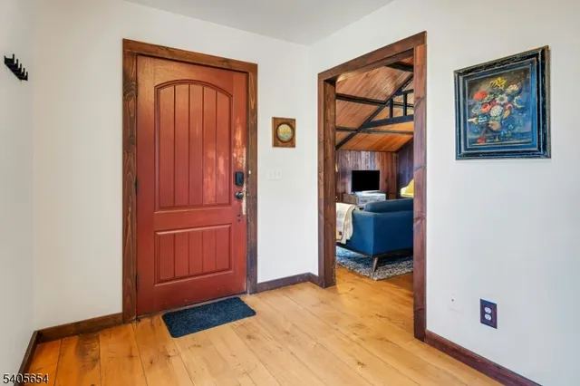 a view of a hallway with wooden floor and closet