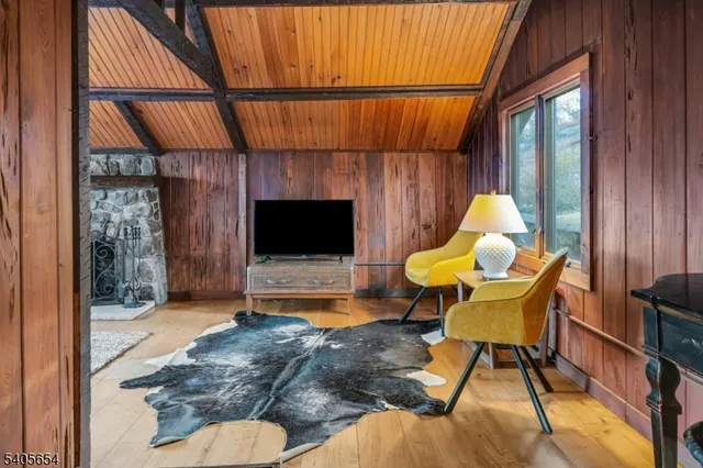 a living room with furniture a flat screen tv and a large window