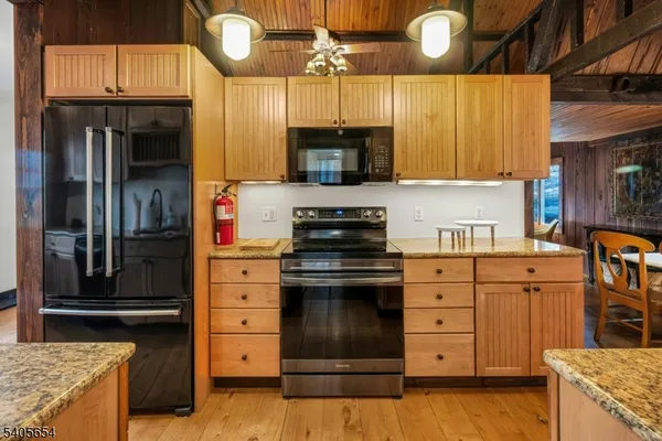 a kitchen with stainless steel appliances granite countertop a stove and a refrigerator