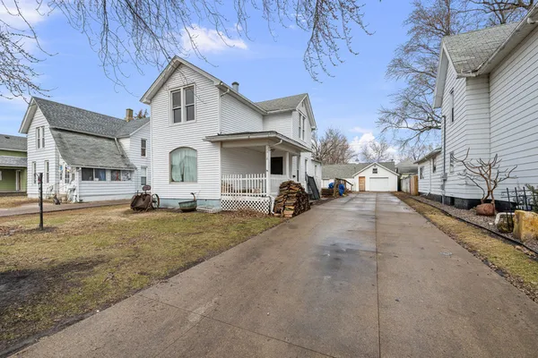 a view of a house with a yard and sitting area