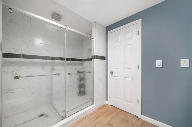 a bathroom with a glass shower door