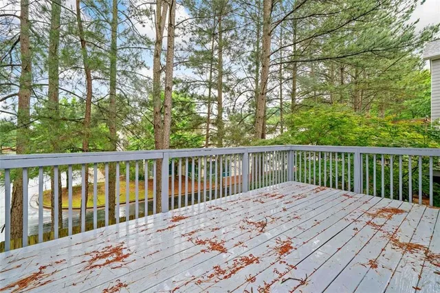 a view of balcony with wooden floor and fence