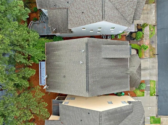 an aerial view of a house with a yard