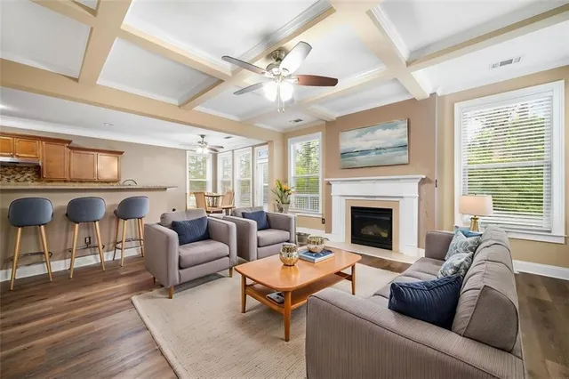 a living room with furniture fireplace and a large window