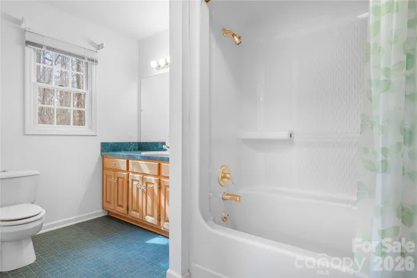 a bathroom with a bathtub a toilet and a shower
