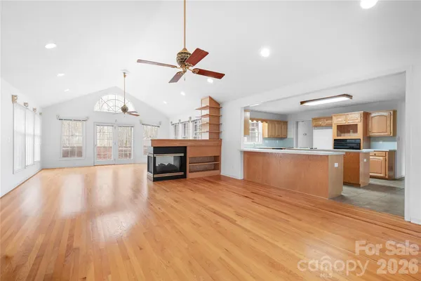 a view of a room with kitchen and fireplace