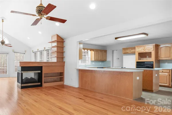 a kitchen with stainless steel appliances granite countertop a stove cabinets and wooden floor