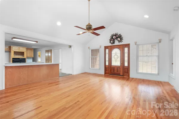 a view of a kitchen with wooden floor and a ceiling fan