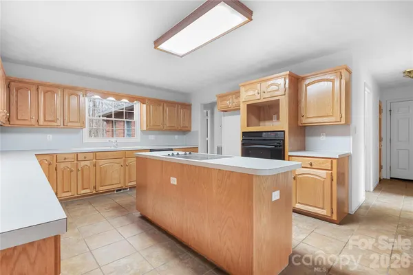a kitchen with stainless steel appliances granite countertop a stove and a sink