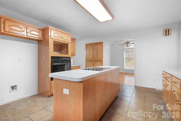 a kitchen with stainless steel appliances granite countertop a refrigerator a stove and a sink