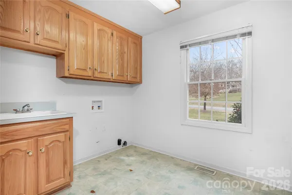 a room with wooden cabinets and a window