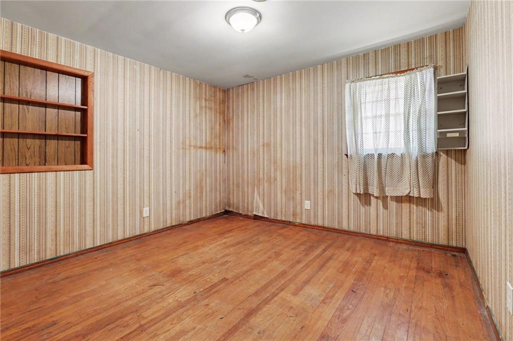 7019 Lake View Lane Doraville, GA 30360 - Photo 17 of 32 an empty room with wooden floor and windows