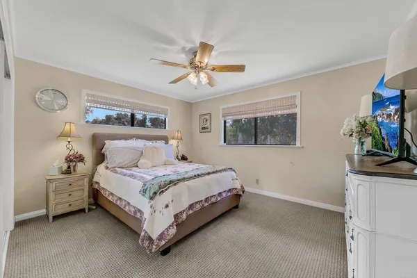 a spacious bedroom with a bed and a chandelier