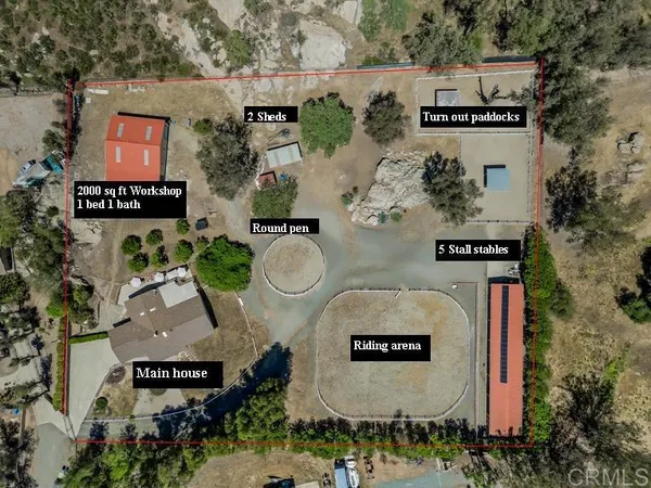 an aerial view of residential house with outdoor space and parking