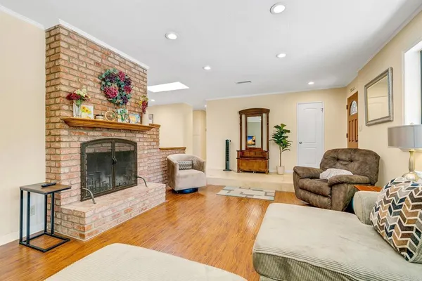 a living room with furniture large window and a fireplace