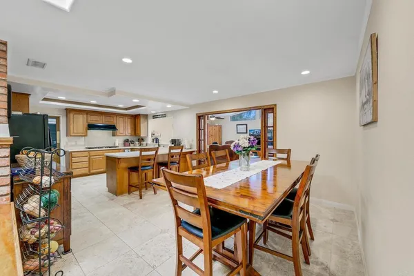 a kitchen with stainless steel appliances kitchen island granite countertop a stove and a refrigerator