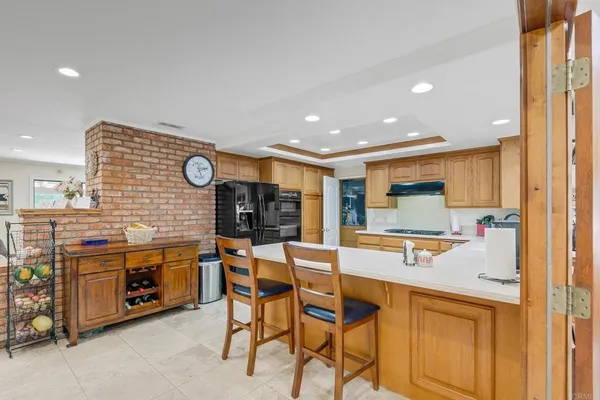 a kitchen with stainless steel appliances granite countertop a refrigerator and a stove