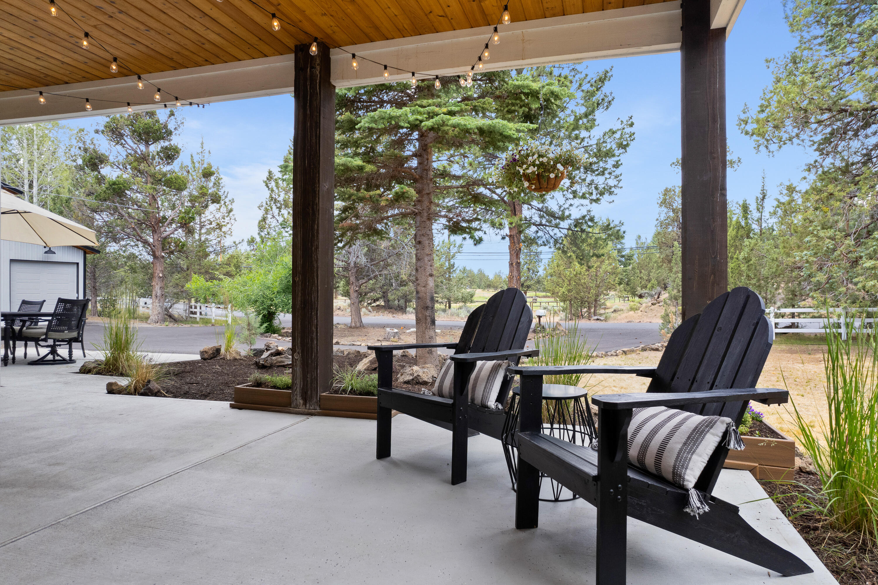 64732 Hunnell Road Bend, OR 97703 - Photo 7 of 51 a view of a patio with couple of chairs and a fountain