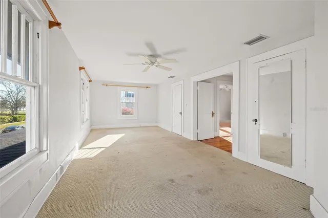 a view of a big room with closet and windows