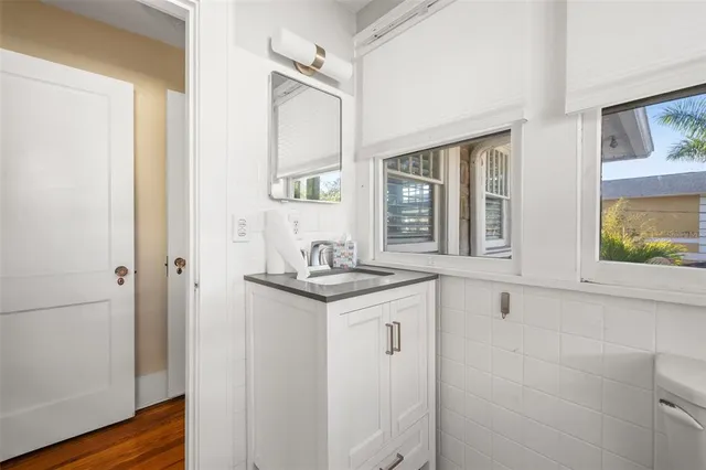 a bathroom with a granite countertop sink and a mirror