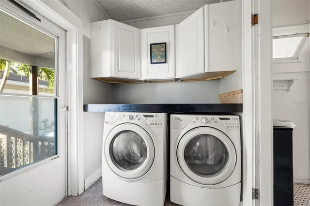 a utility room with sink dryer and washer