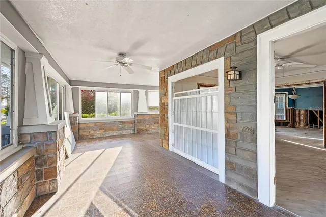 a view of an entryway with wooden floor and a livingroom view