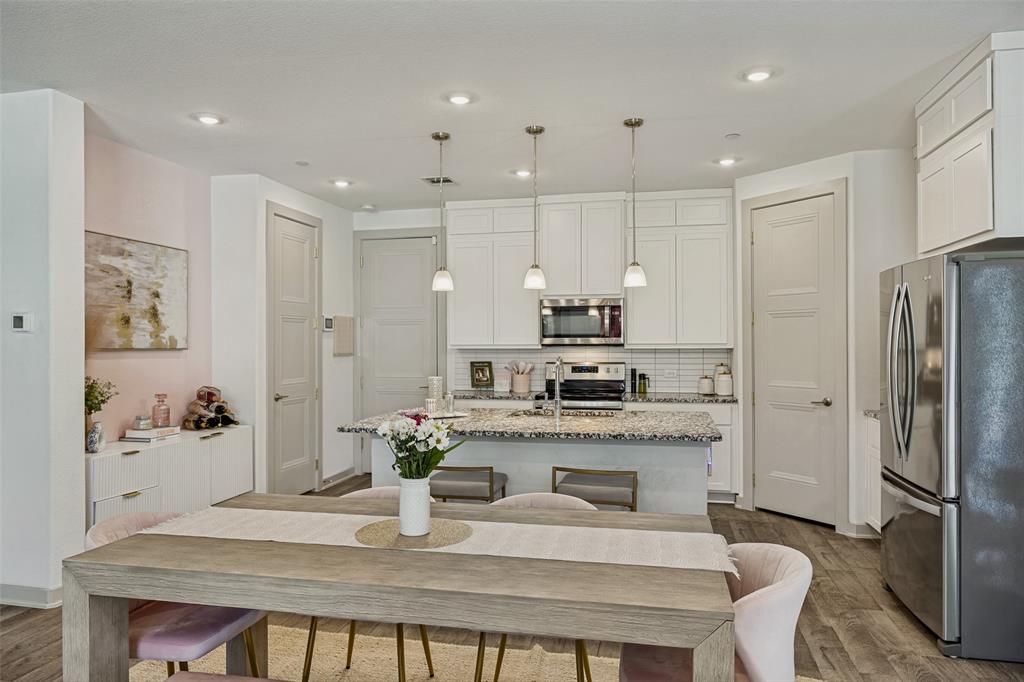 1650 Jessica Lane Allen, TX 75002 - Photo 7 of 25 a kitchen with stainless steel appliances granite countertop sink refrigerator and microwave