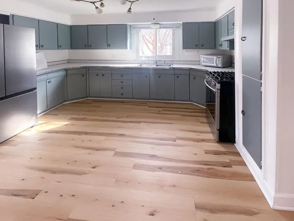 a kitchen with stainless steel appliances granite countertop a refrigerator sink and cabinets